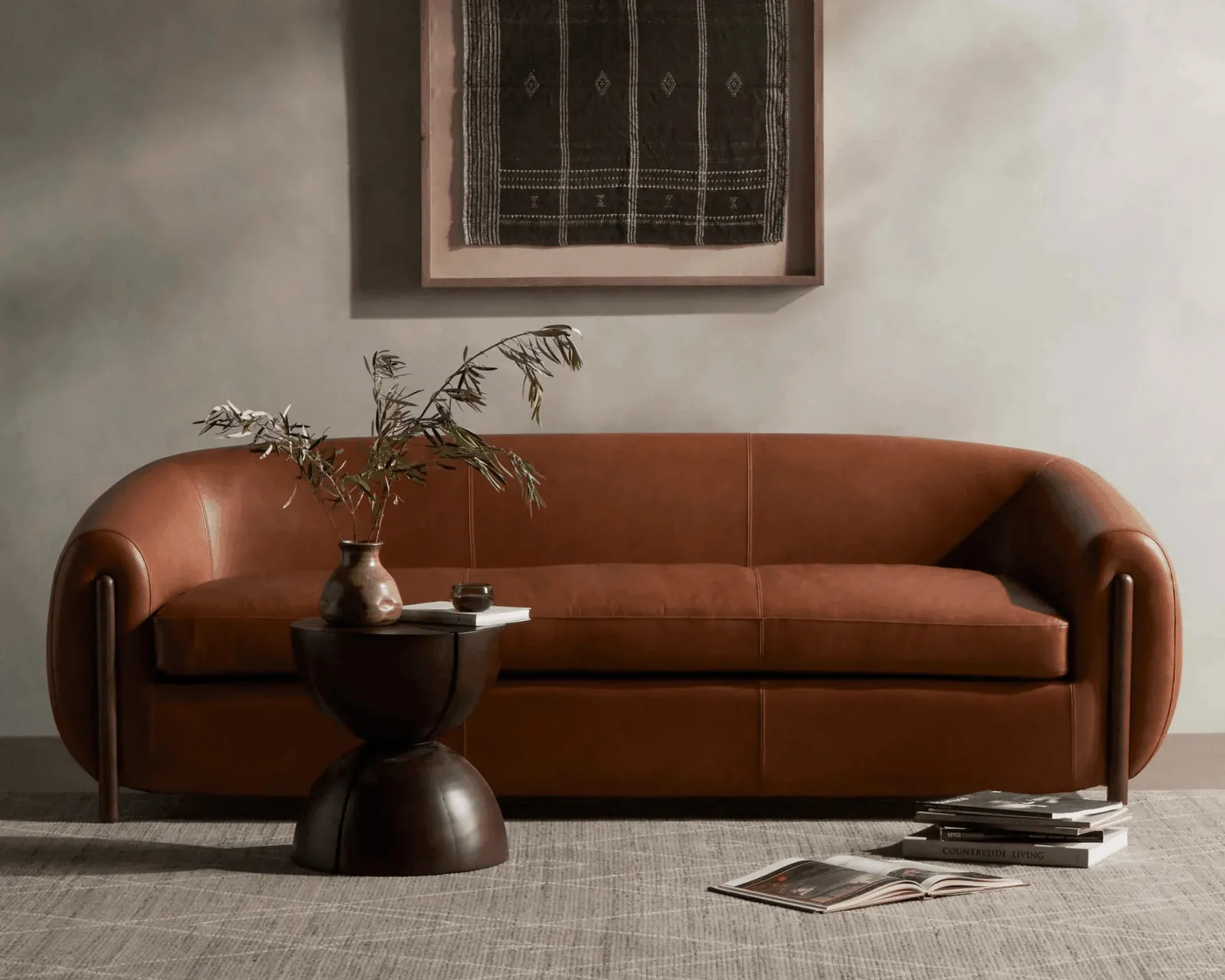 A delivery professional bringing a new sofa into a home for white-glove installation.