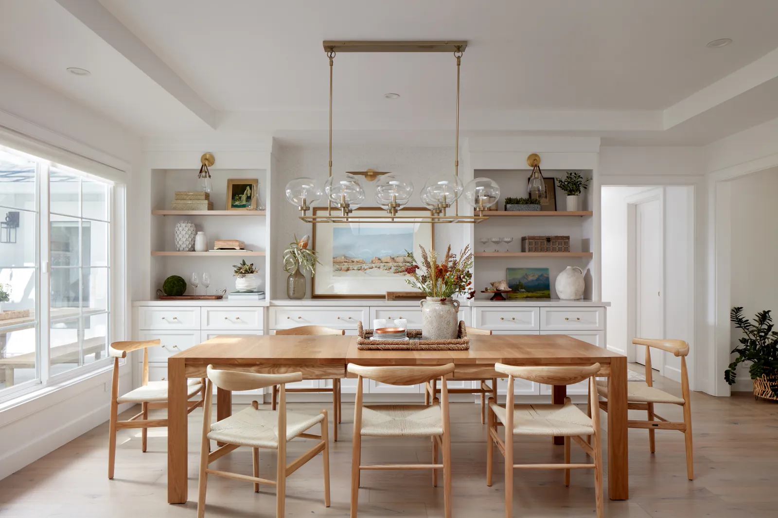 An extendable dining table mechanism shown in a small, bright apartment.