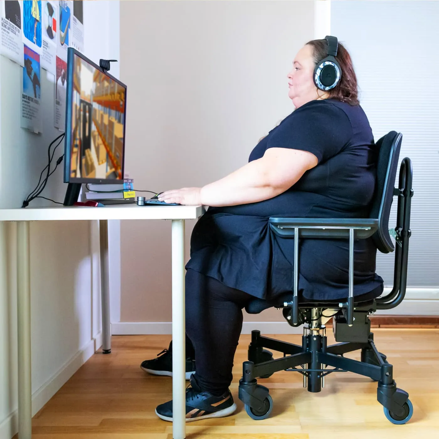 A person demonstrating the correct sitting posture in an adjustable ergonomic office chair.