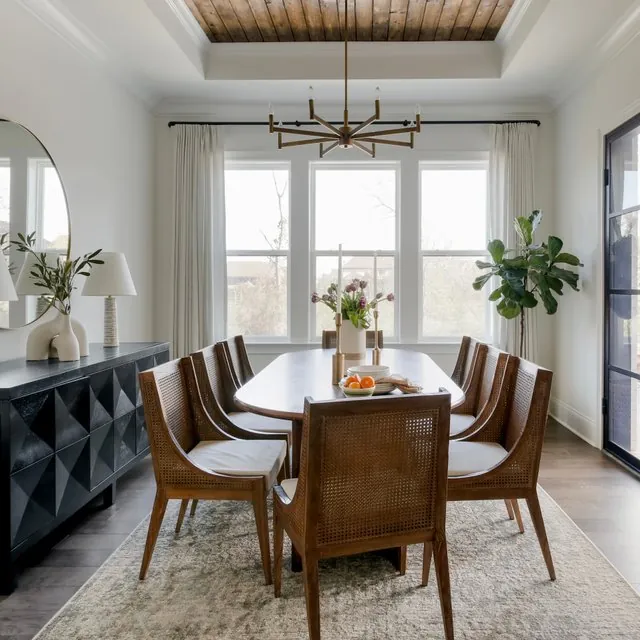A slim dining chair positioned at a table to show how many dining room chairs you need.