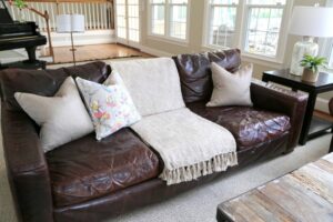 How to Lighten Up a Brown Couch With Textiles and Lighting