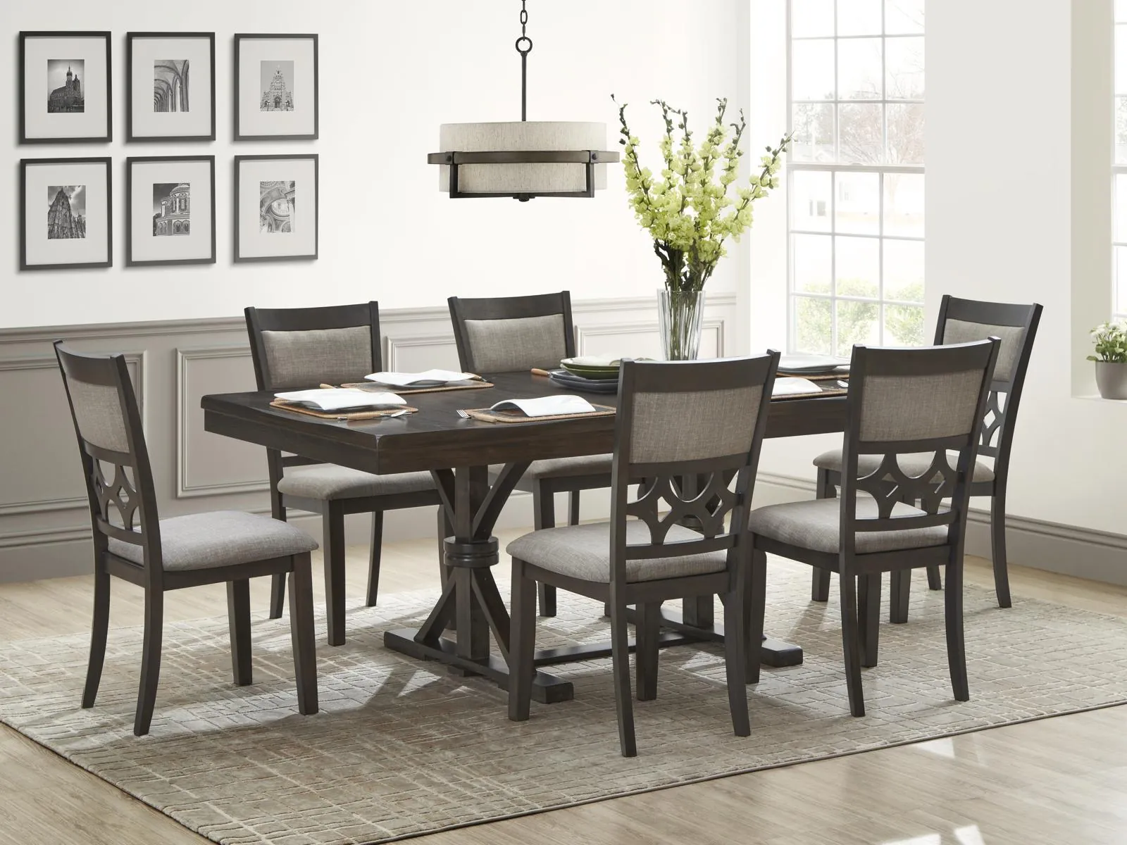 Cleaning a wooden dining room table with a microfiber cloth before storage.