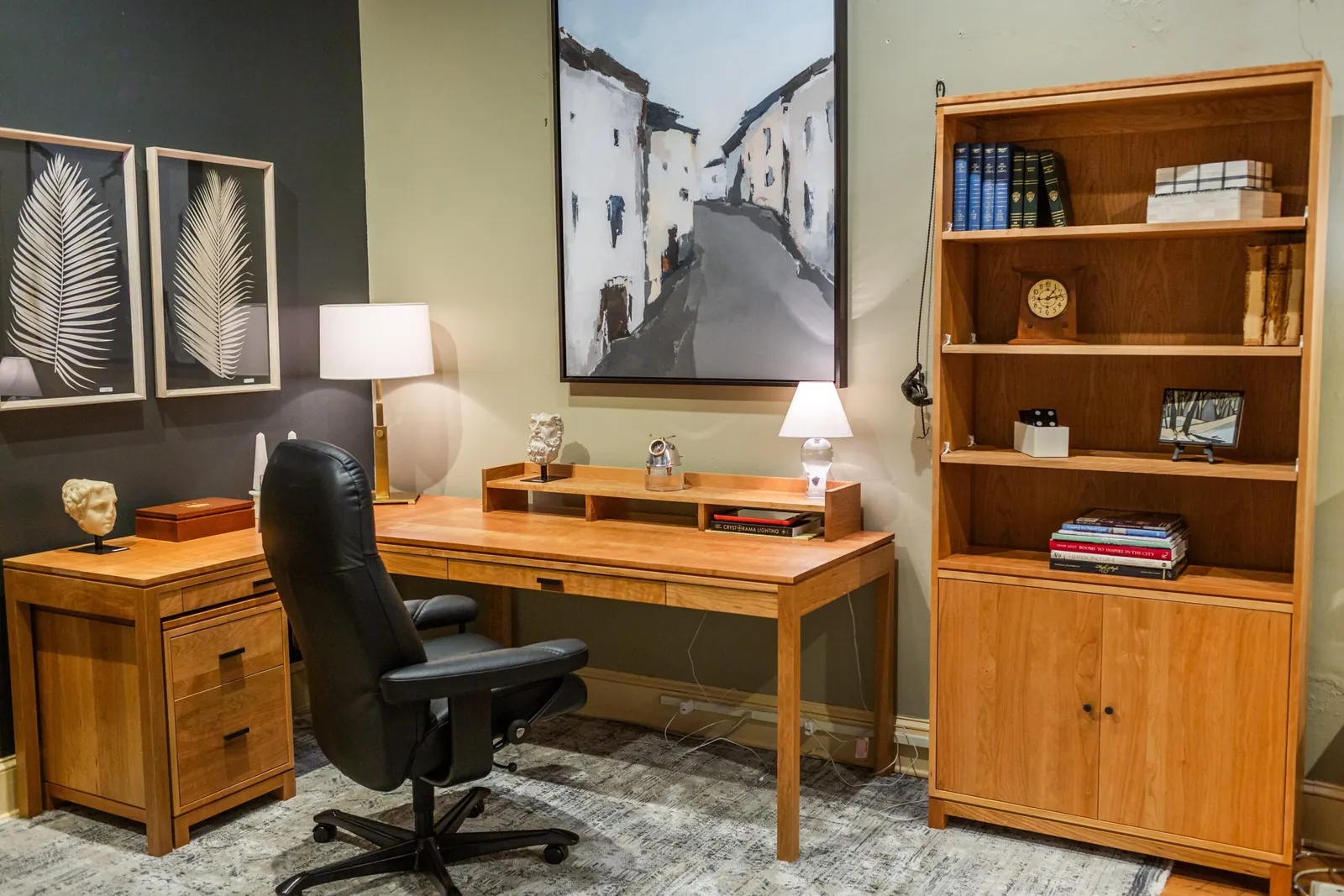 Comparison of a modern compact desk and a large antique desk setup.