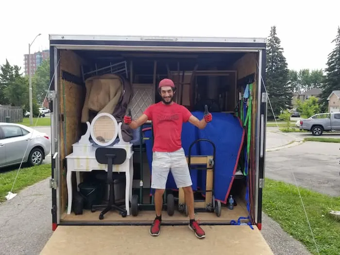 Dining chairs nested together inside a moving truck to save space during transport.