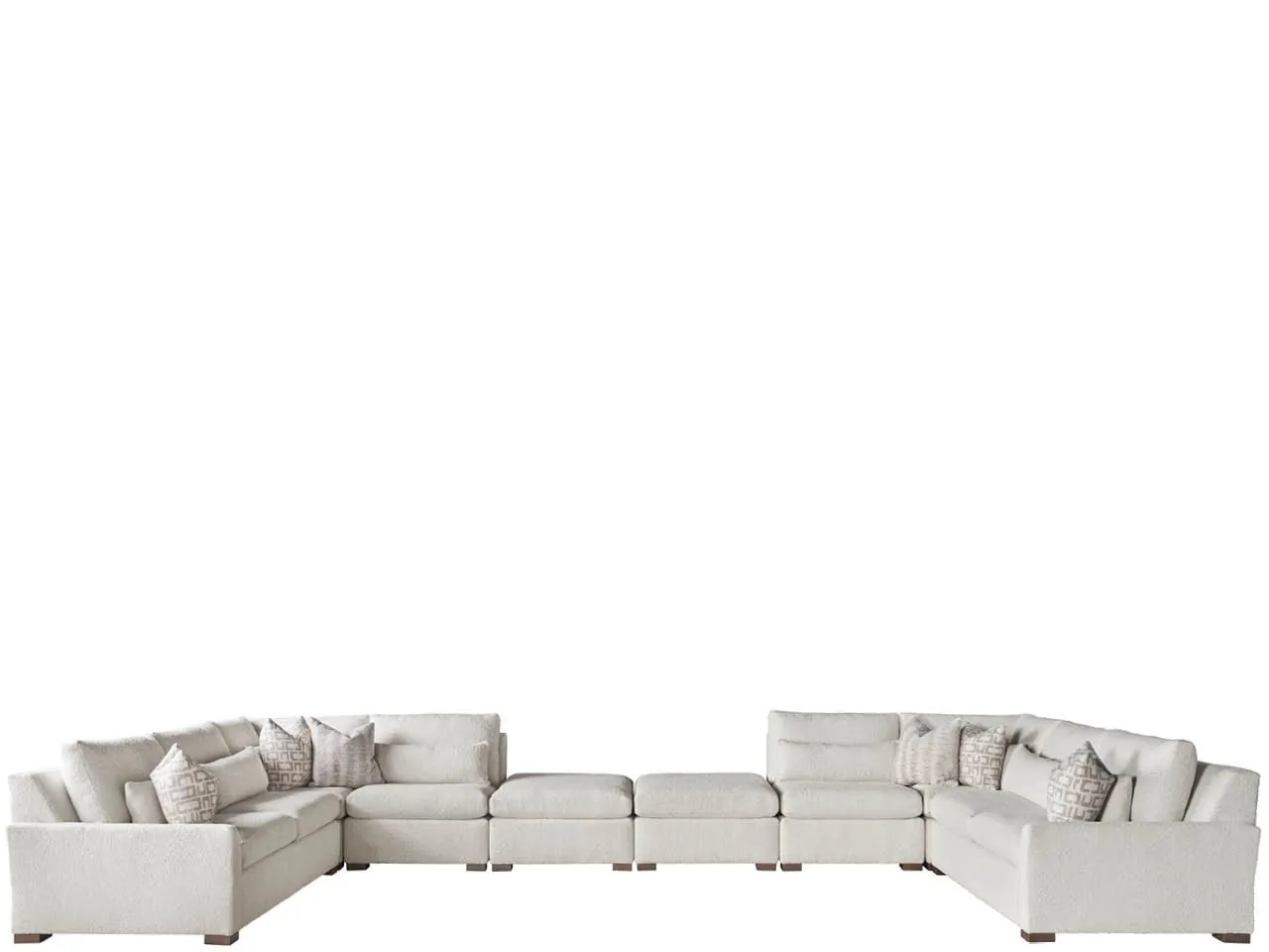 Hands use a fabric shaver to maintain the upholstery of a comfortable sectional sofa.