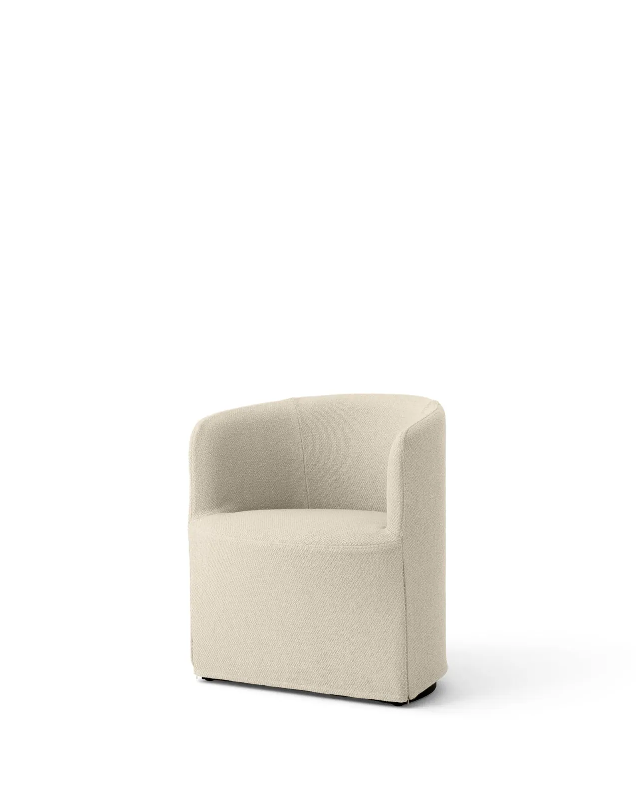 A person using a tool to tuck fabric into a club chair.