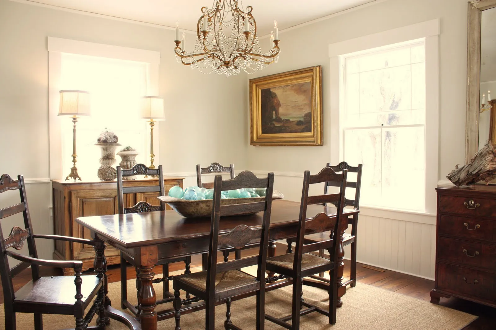 Three different styles of dining tables stand side by side in a bright showroom.