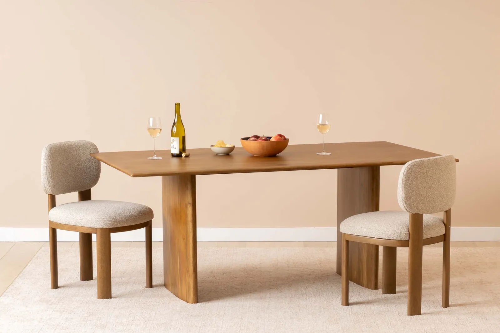 Two people measuring the floor space around a dining room table for clearance.