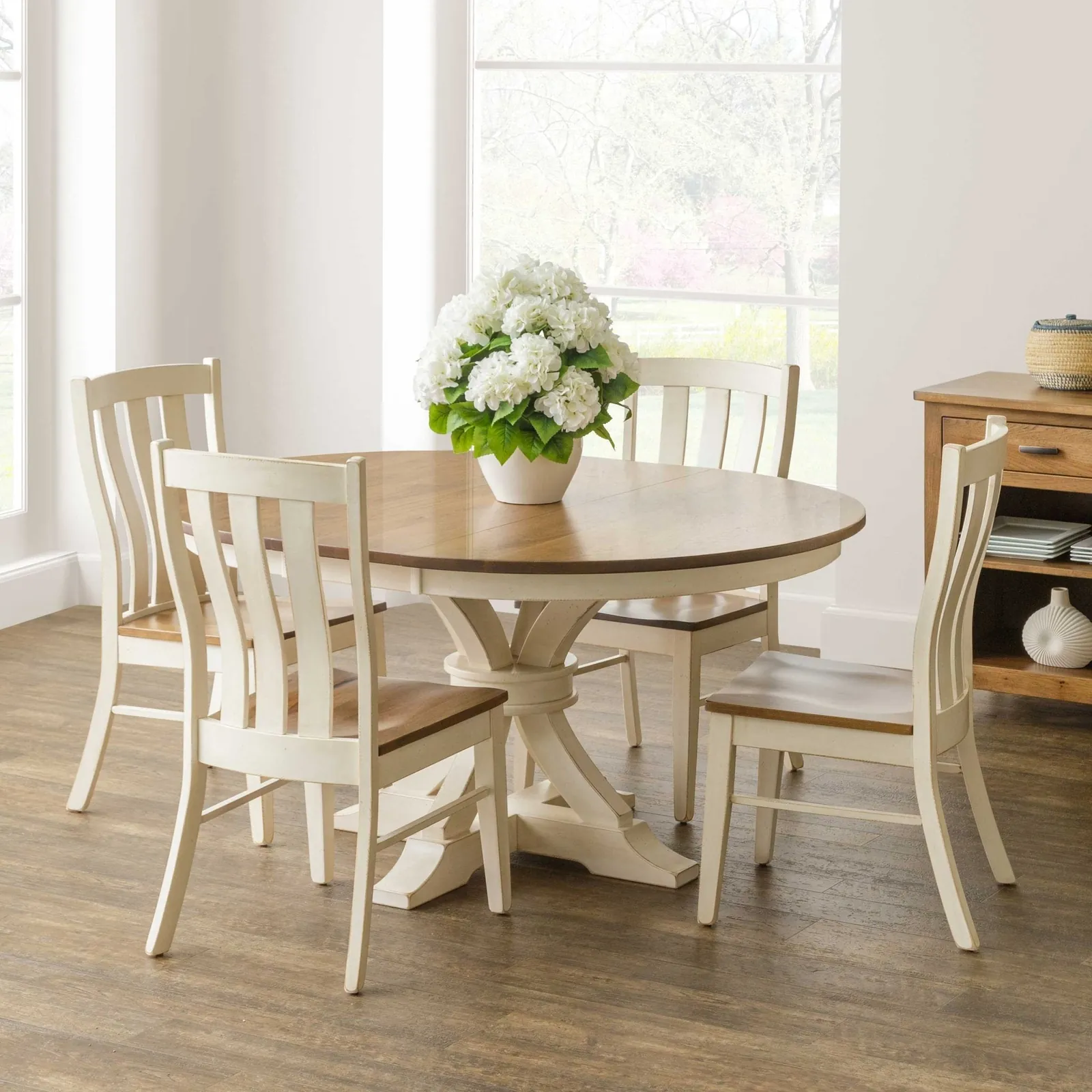 A well-spaced rectangular dining table set in a bright, modern dining room.